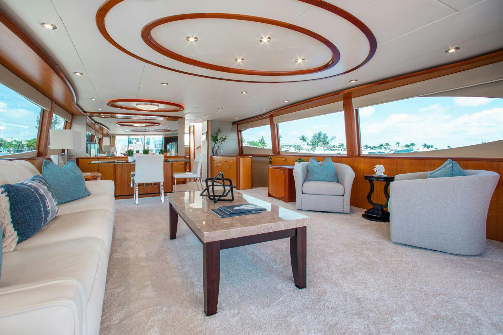 a living room with a table and couches aboard 26 NORTH Yacht for Sale