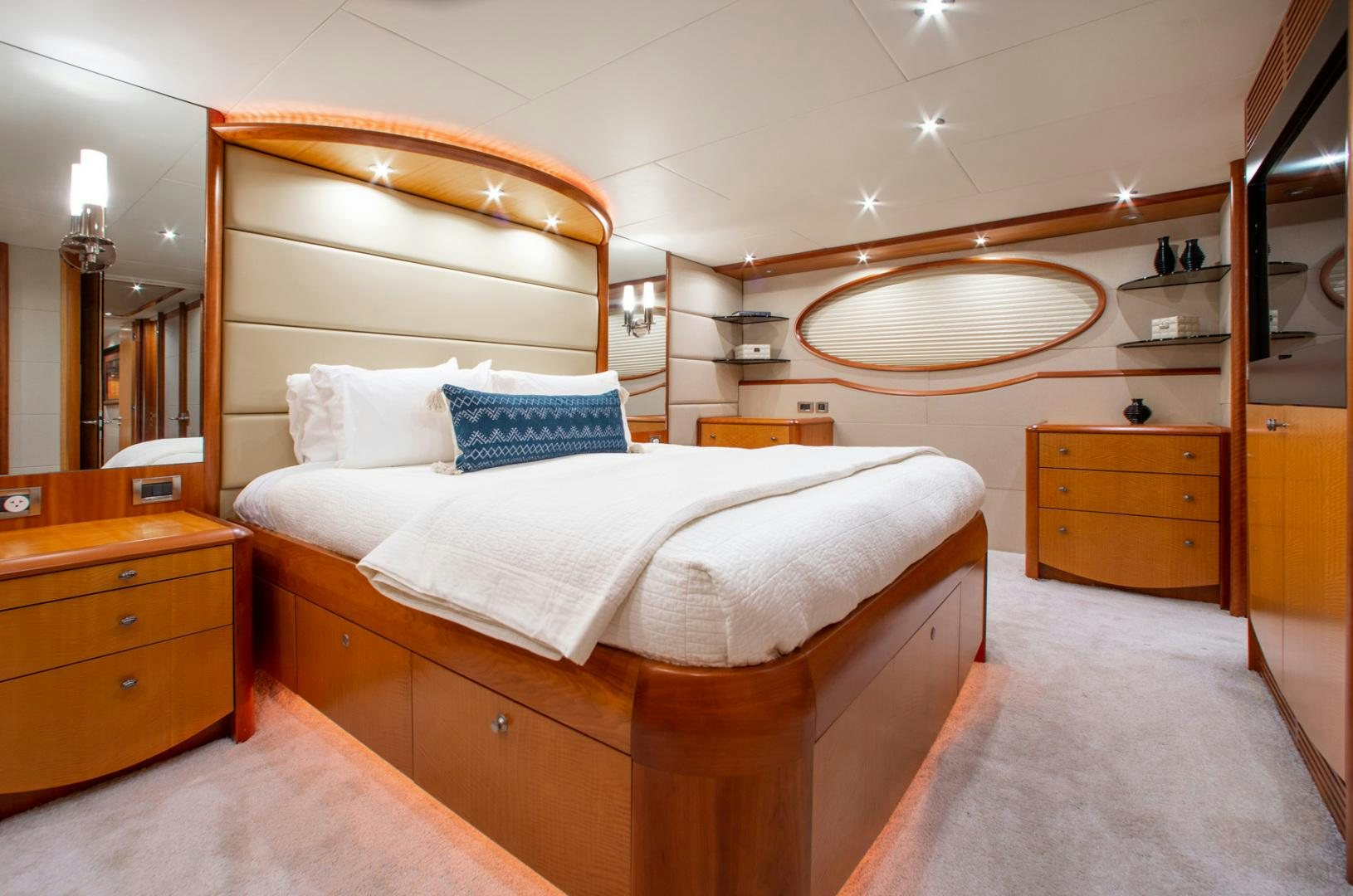 a bedroom with a bed and a mirror aboard 26 NORTH Yacht for Sale
