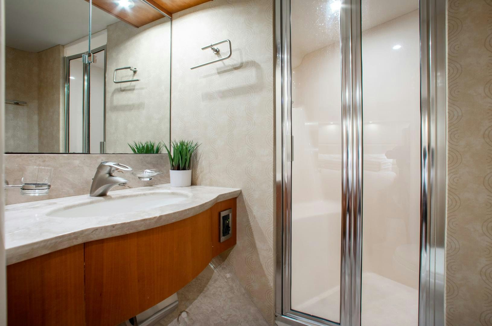 a bathroom with a glass shower aboard 26 NORTH Yacht for Sale