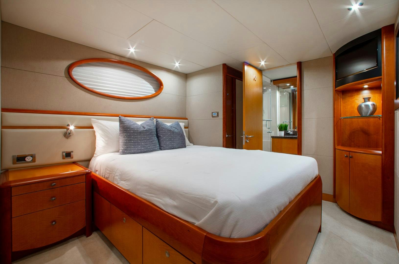 a bedroom with a bed and a mirror aboard 26 NORTH Yacht for Sale