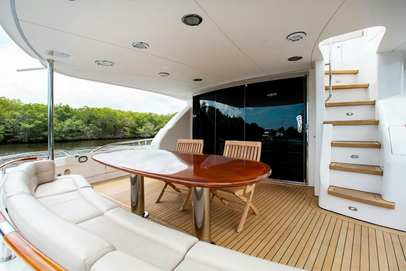 a table and chairs on a deck aboard 26 NORTH Yacht for Sale