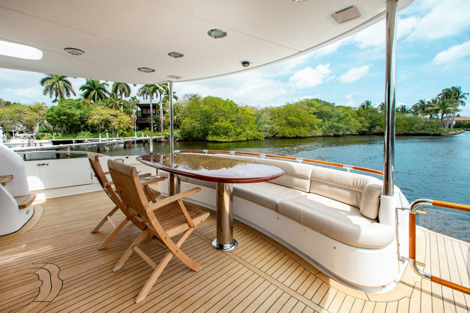 a table and chairs on a deck by a pool aboard 26 NORTH Yacht for Sale
