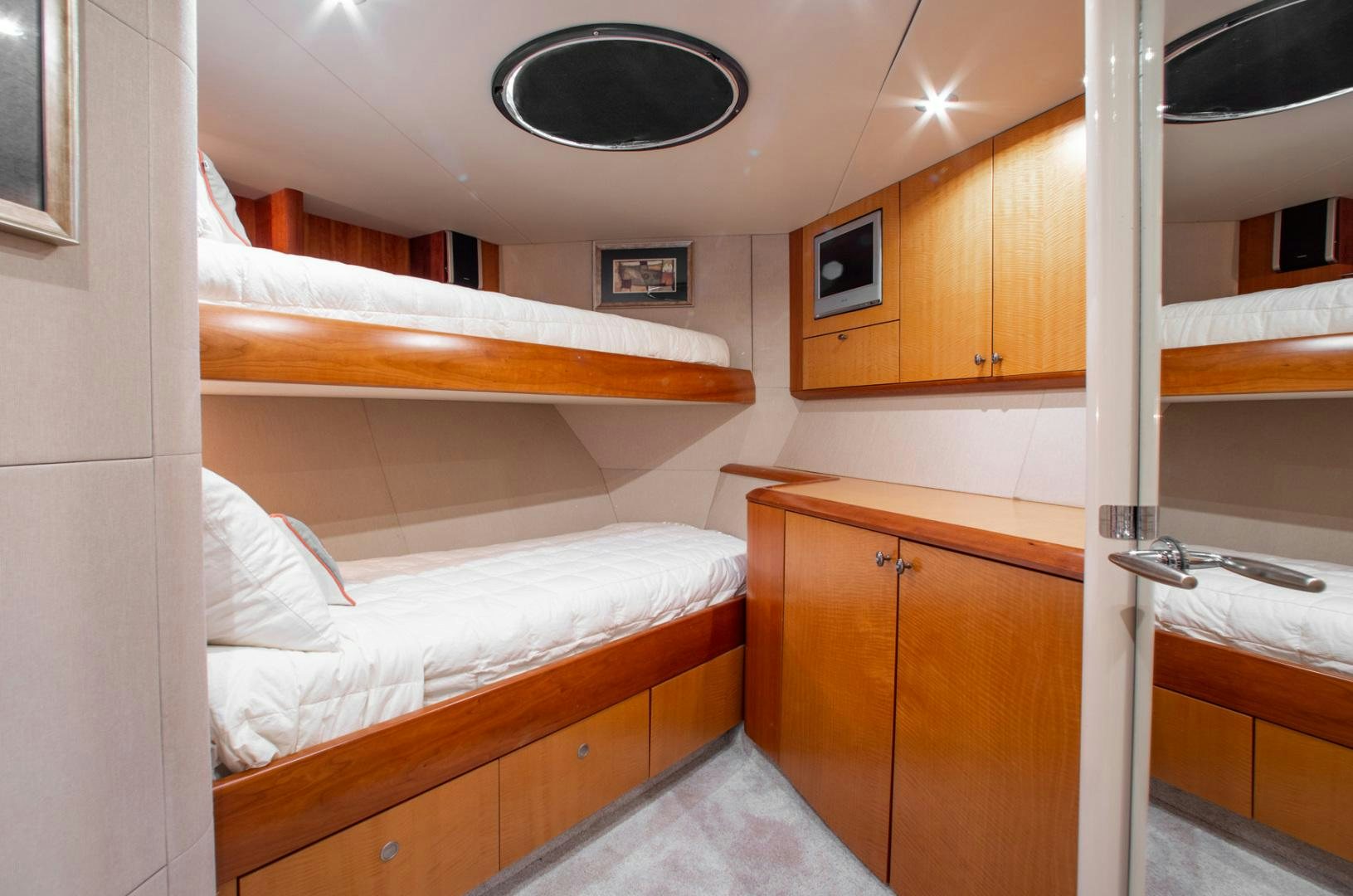 a room with a bed and a desk aboard 26 NORTH Yacht for Sale