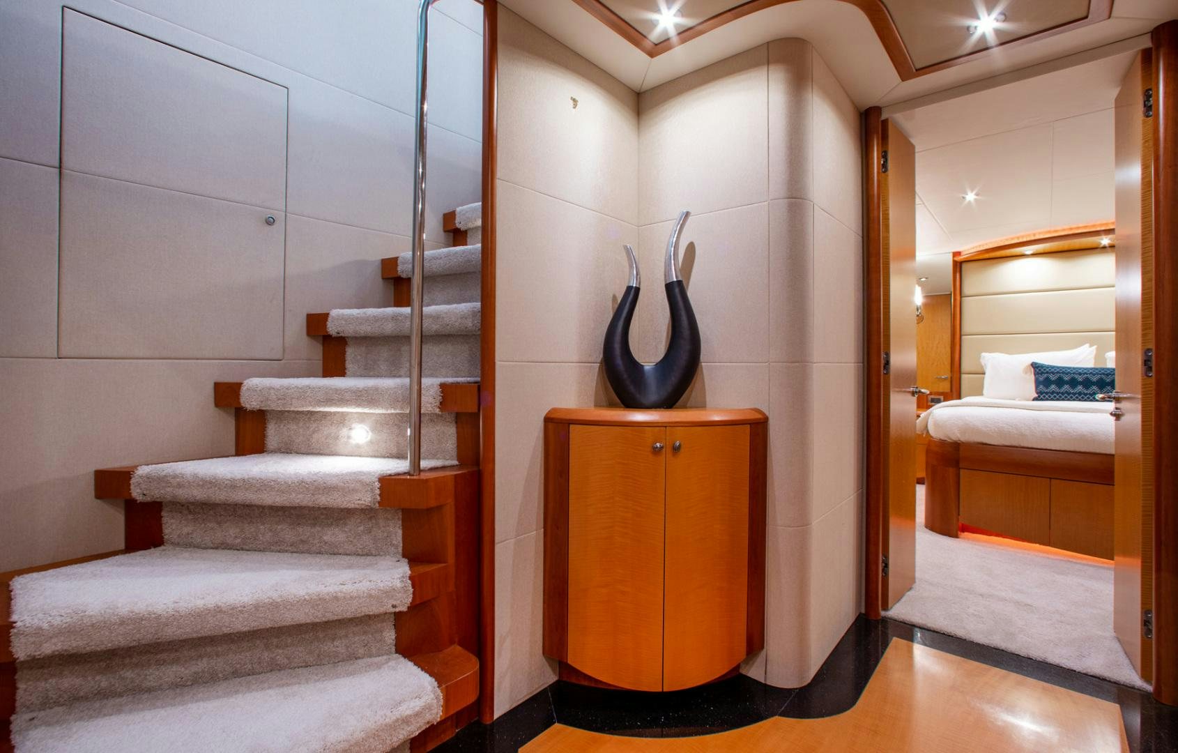 a room with a staircase and a bed aboard 26 NORTH Yacht for Sale