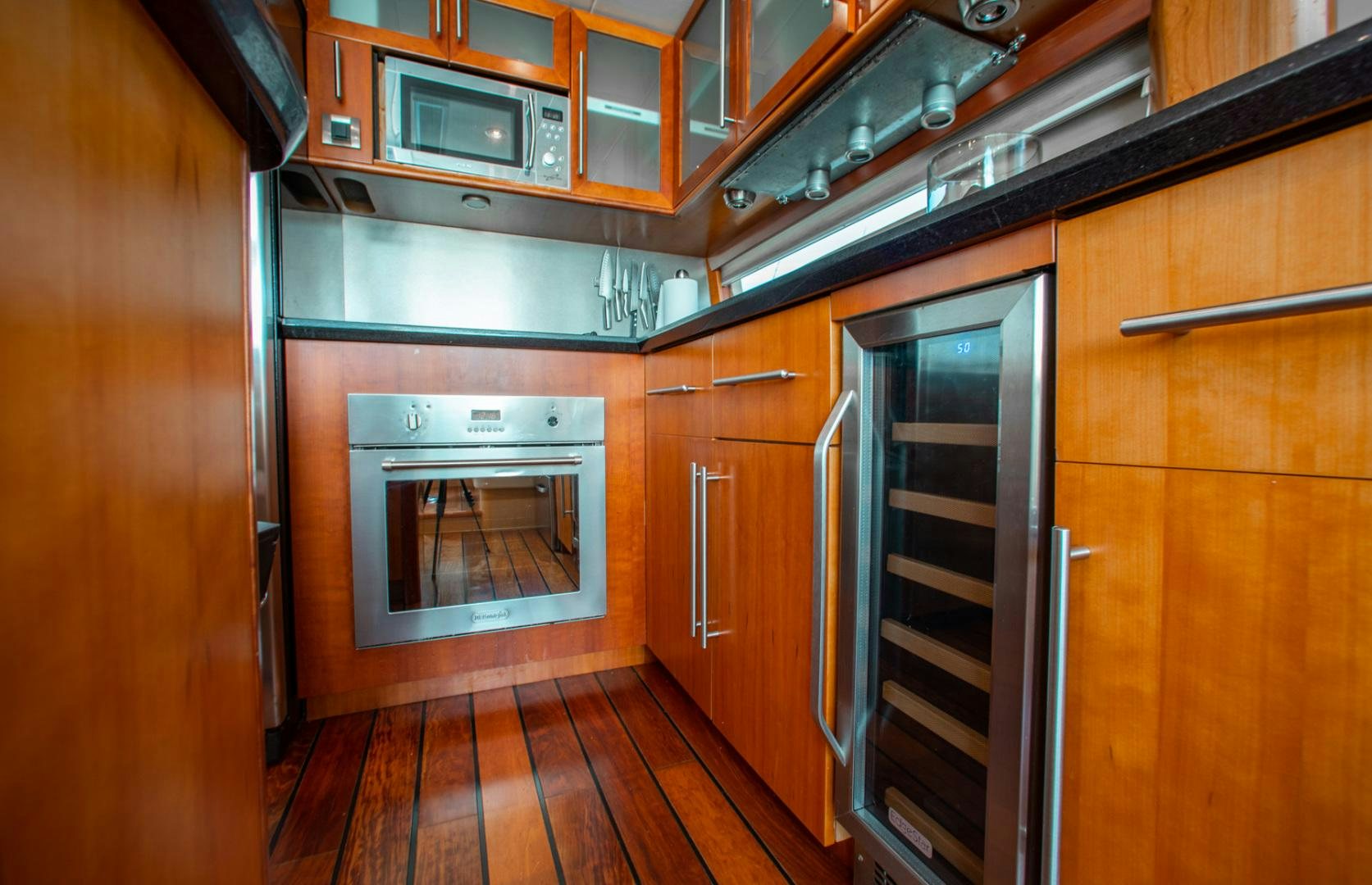 a kitchen with wooden cabinets aboard 26 NORTH Yacht for Sale