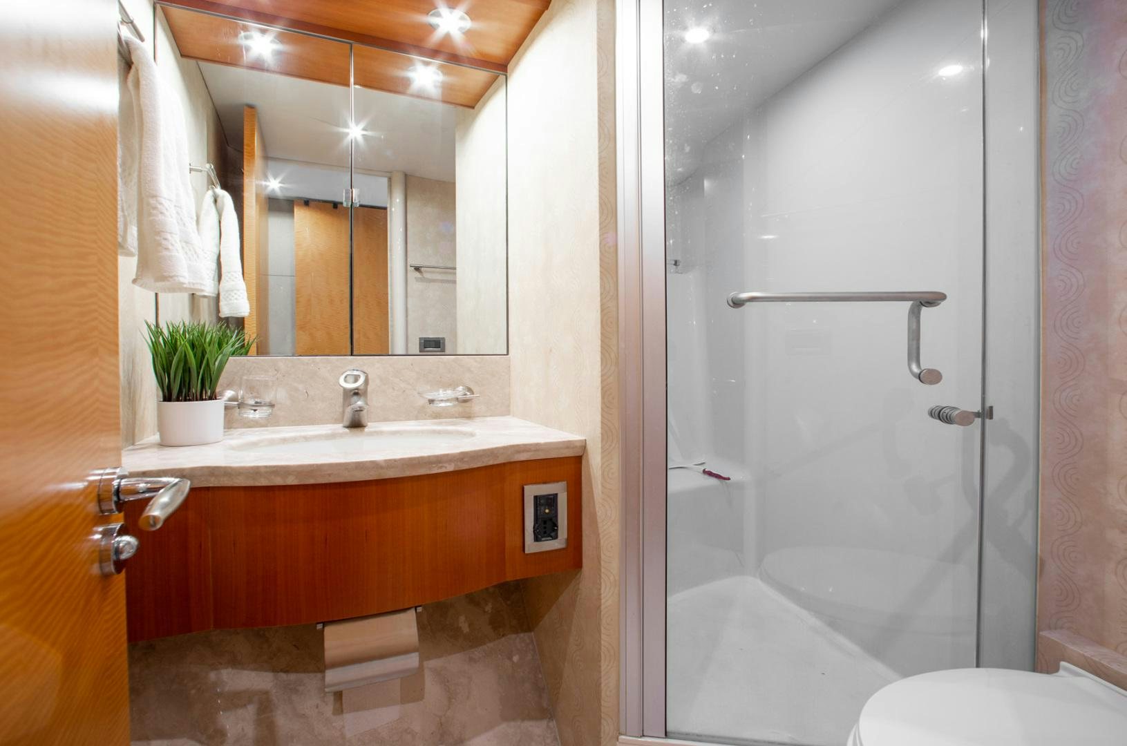 a bathroom with a sink and a mirror aboard 26 NORTH Yacht for Sale