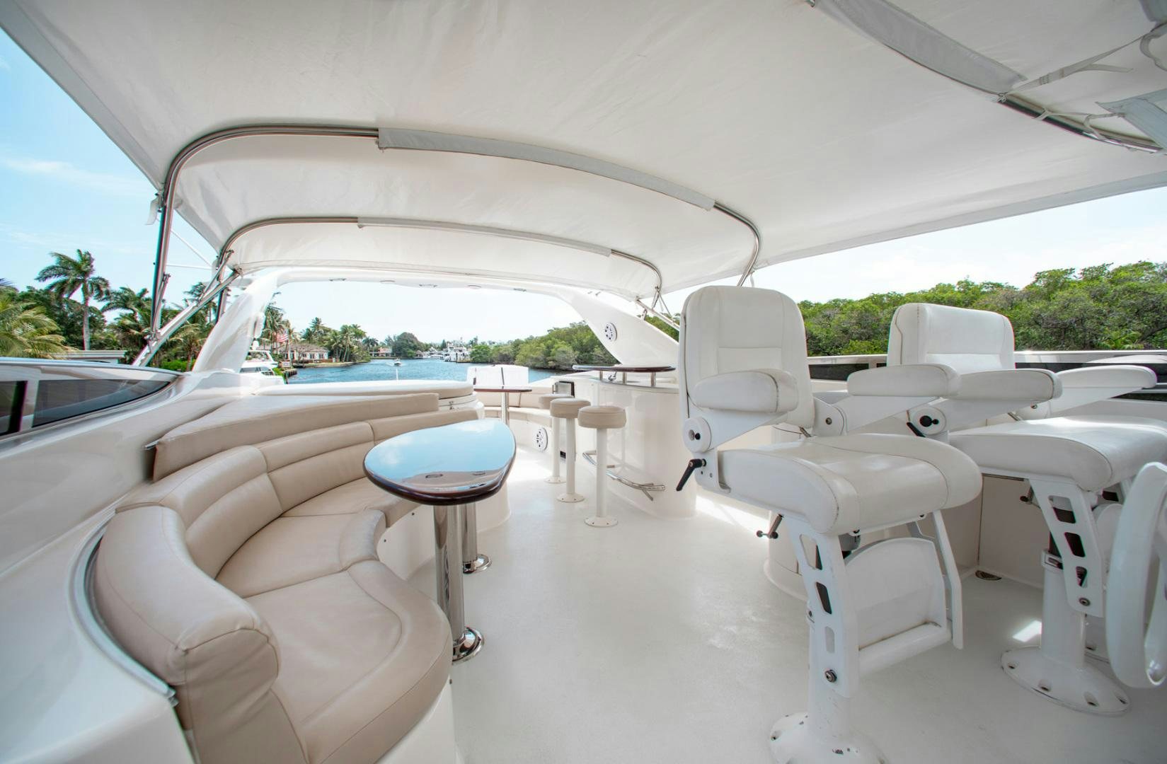 a white tent with chairs and tables aboard 26 NORTH Yacht for Sale