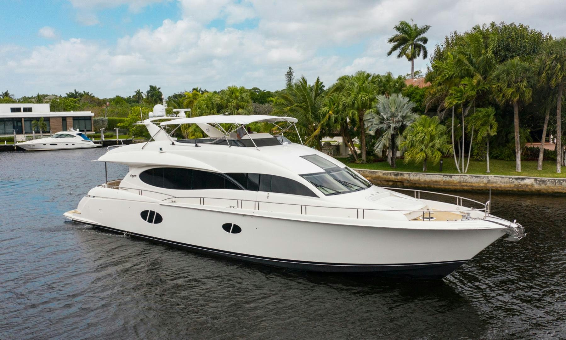 a white yacht on a beach aboard 26 NORTH Yacht for Sale