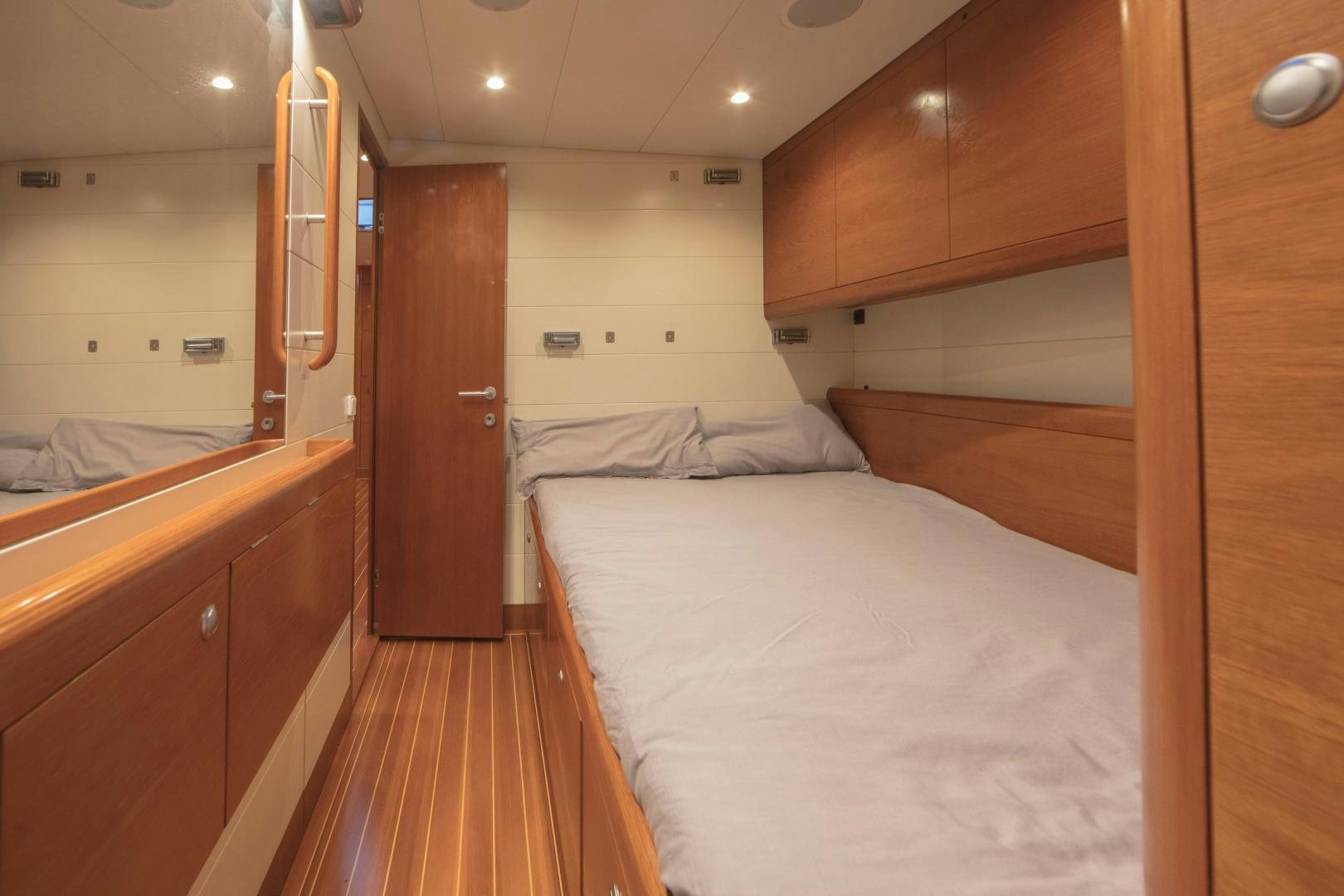 a room with wooden cabinets and a bed aboard GREY GOOSE Yacht for Sale