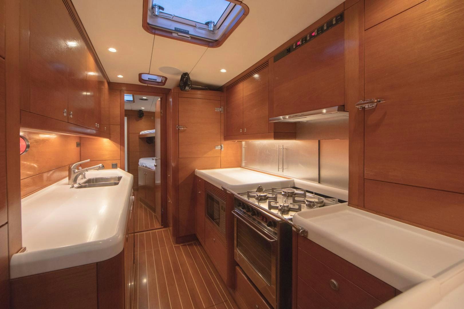a kitchen with wooden cabinets aboard GREY GOOSE Yacht for Sale