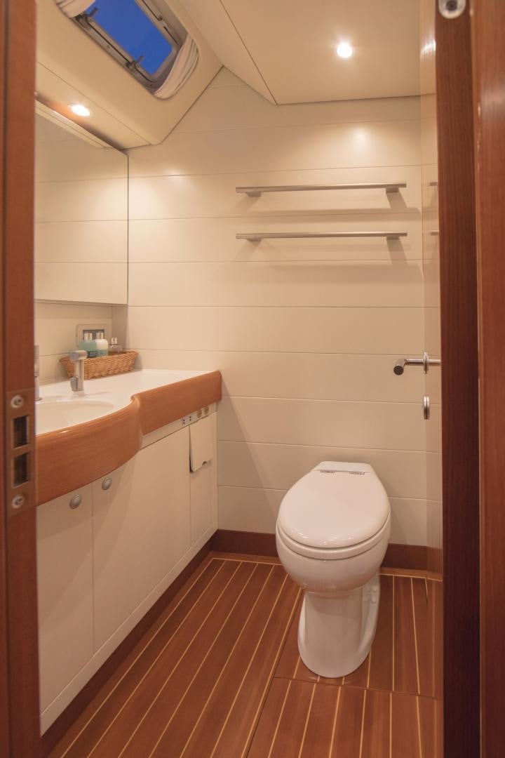 a bathroom with a toilet sink and a mirror aboard GREY GOOSE Yacht for Sale