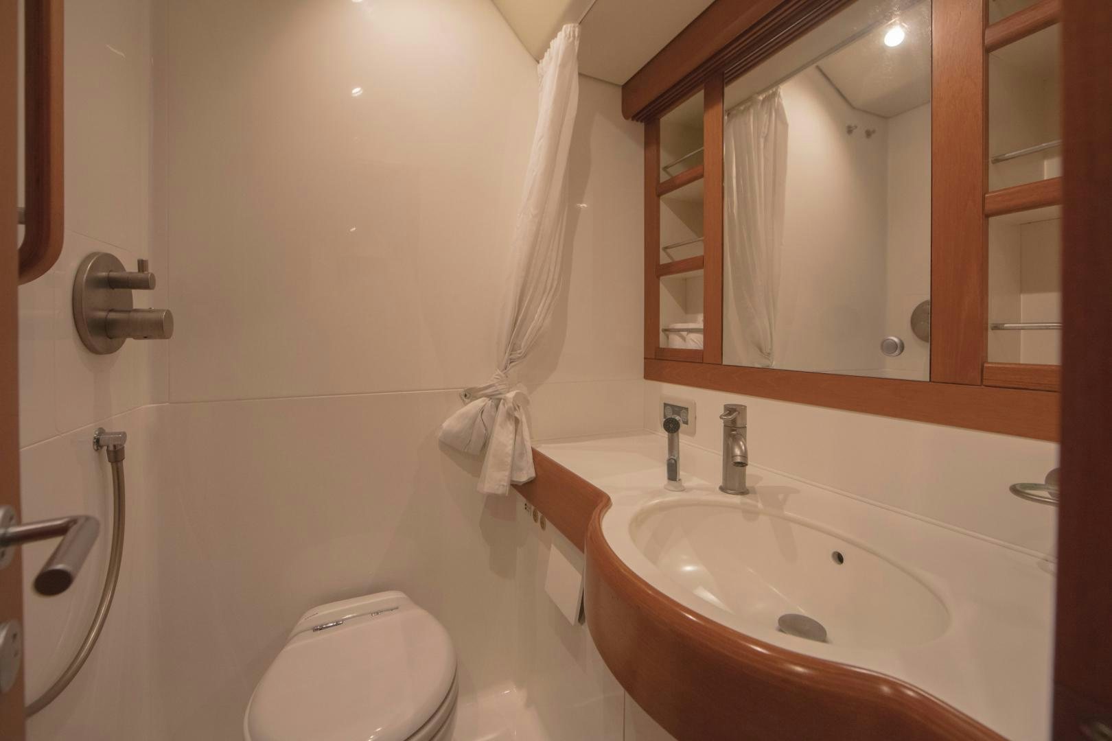 a bathroom with a toilet and a sink aboard GREY GOOSE Yacht for Sale