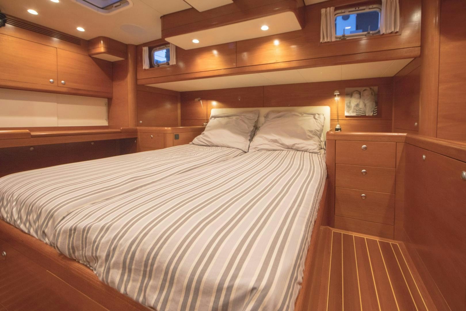 a bed with a white sheet aboard GREY GOOSE Yacht for Sale