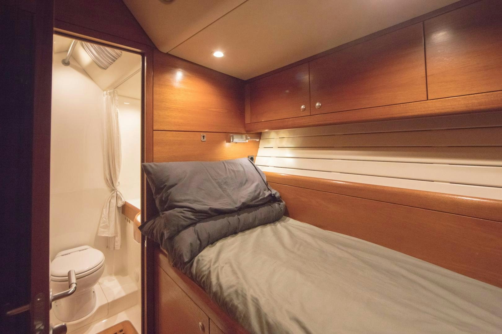 a bedroom with a bed and a closet aboard GREY GOOSE Yacht for Sale