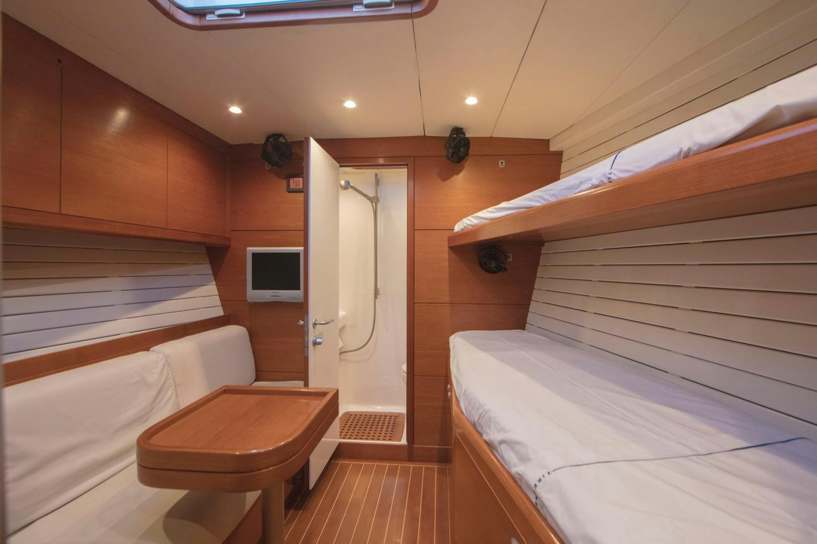 a room with a bed and a table aboard GREY GOOSE Yacht for Sale
