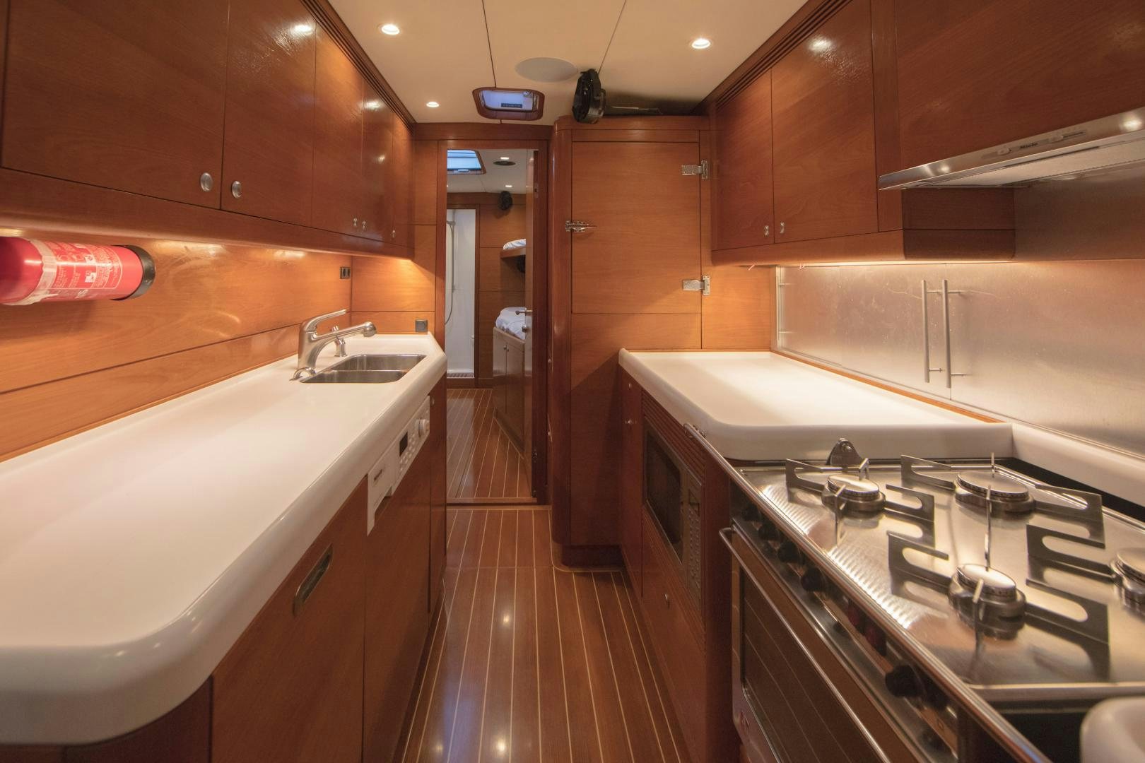 a kitchen with wooden cabinets aboard GREY GOOSE Yacht for Sale