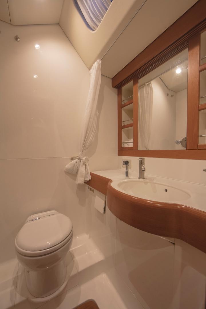 a bathroom with a toilet and a sink aboard GREY GOOSE Yacht for Sale