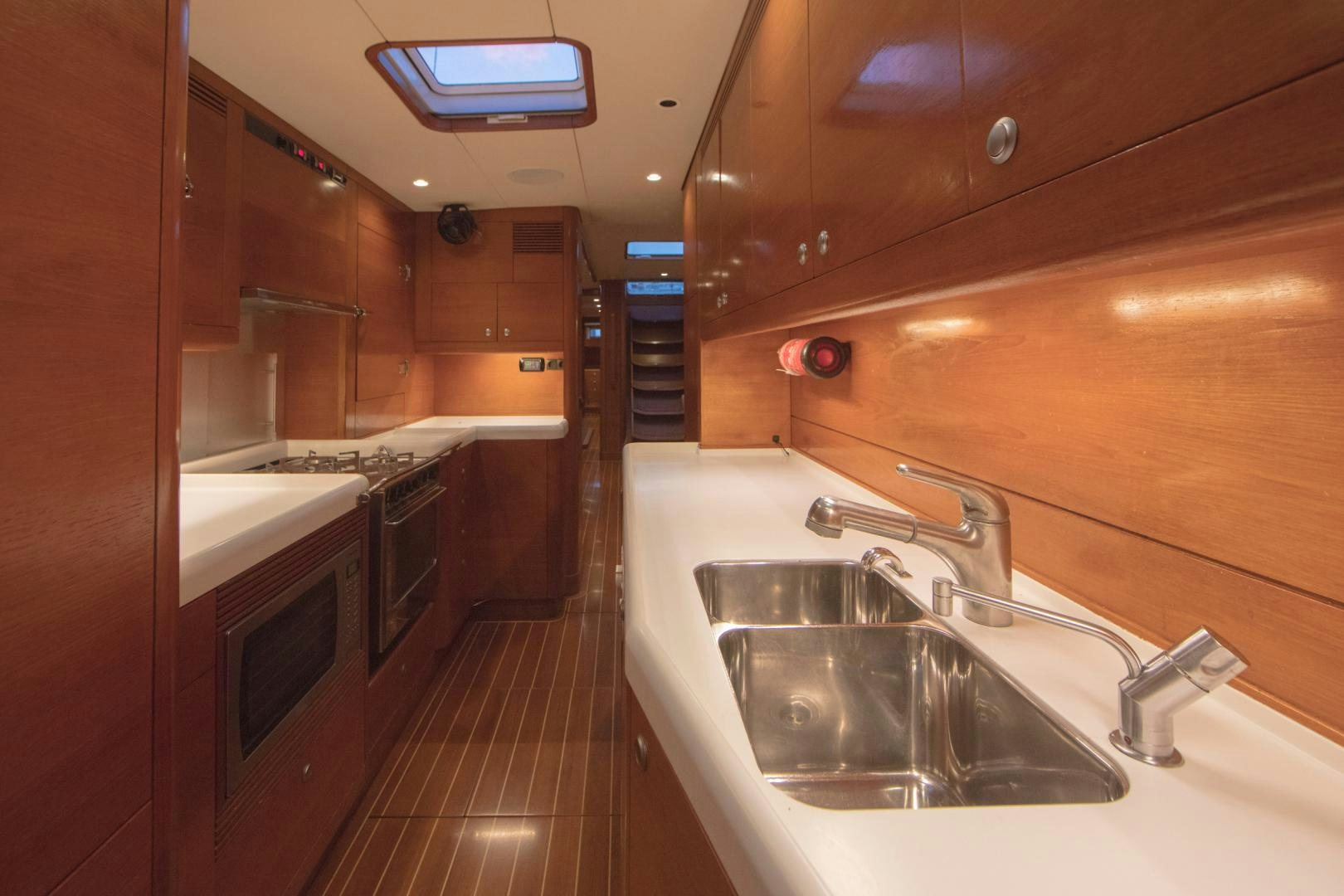 a kitchen with a sink and a microwave aboard GREY GOOSE Yacht for Sale