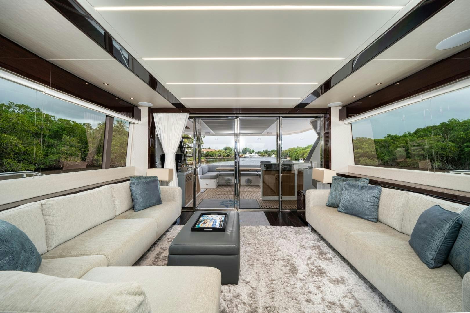 a living room with a couch and a large window aboard TEMPUS FUGIT Yacht for Sale