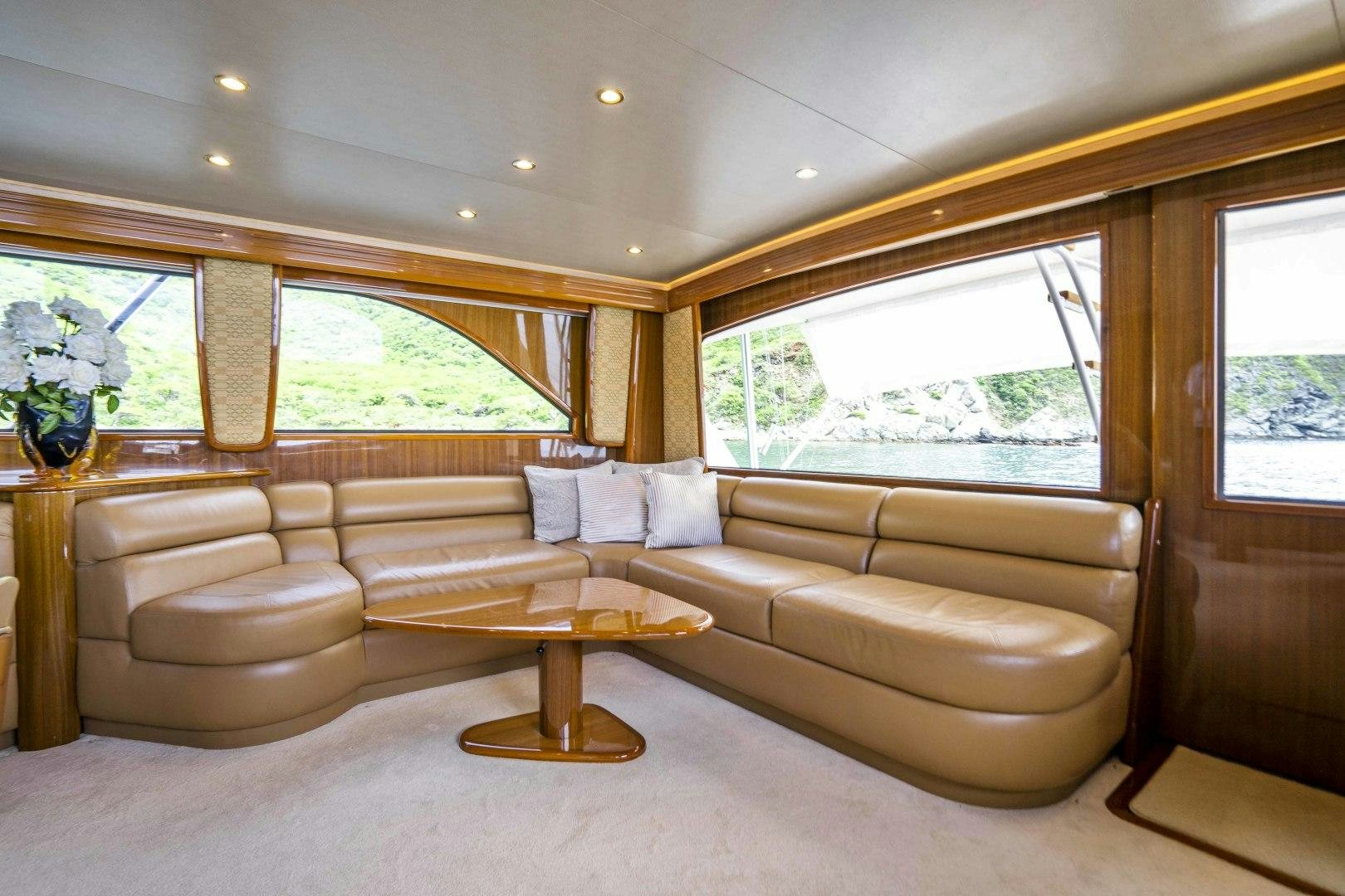 a living room with a couch and a coffee table aboard TRANQUILO Yacht for Sale