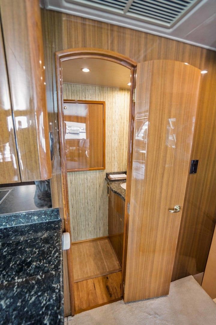 a wooden closet with a glass door aboard TRANQUILO Yacht for Sale