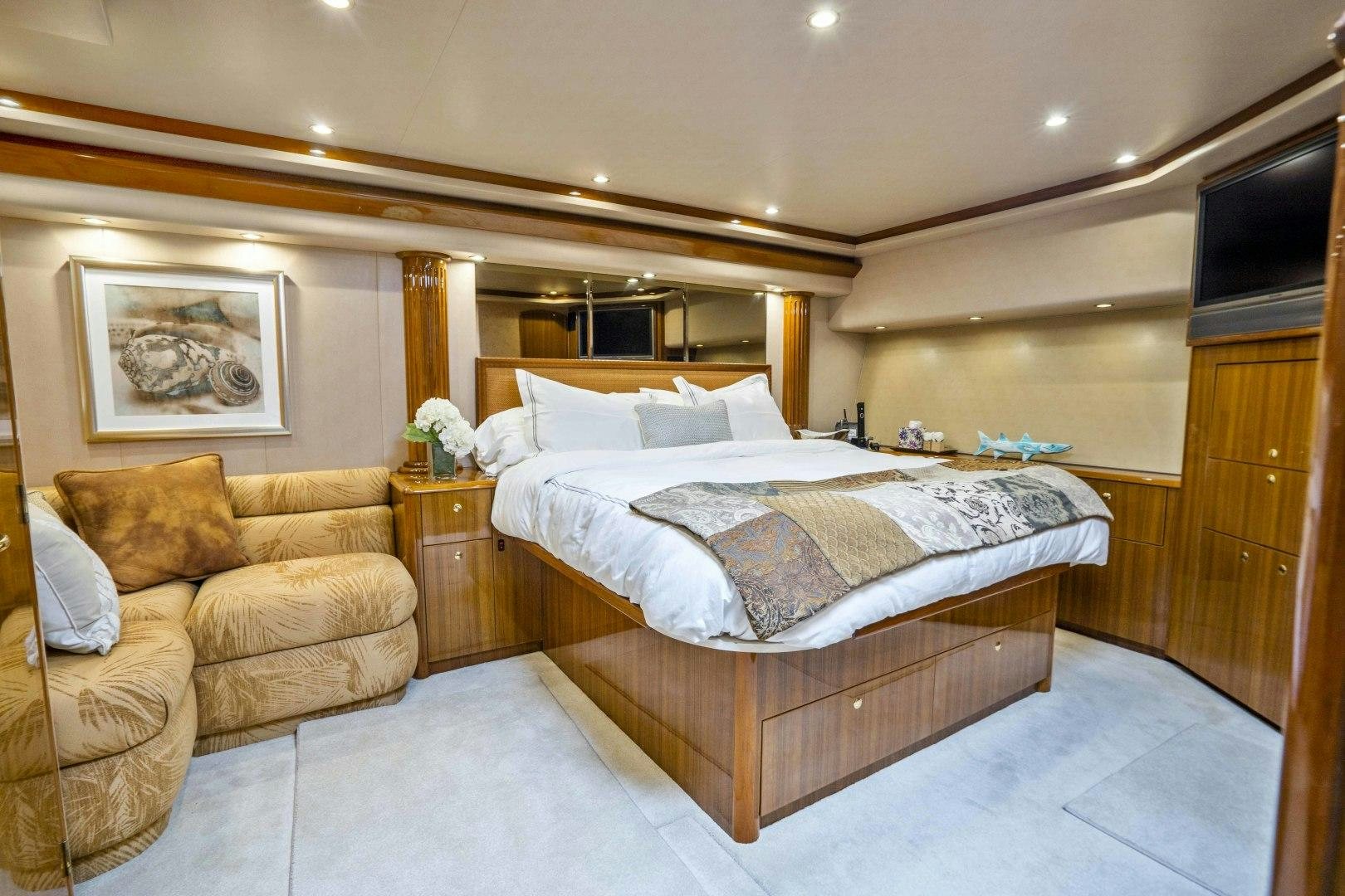 a bedroom with a bed and a couch aboard TRANQUILO Yacht for Sale