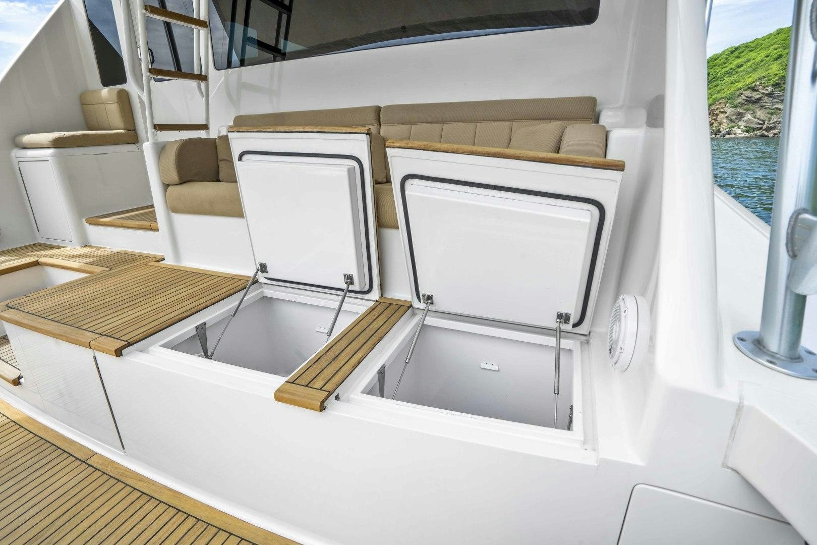 a white boat with a wooden frame aboard TRANQUILO Yacht for Sale