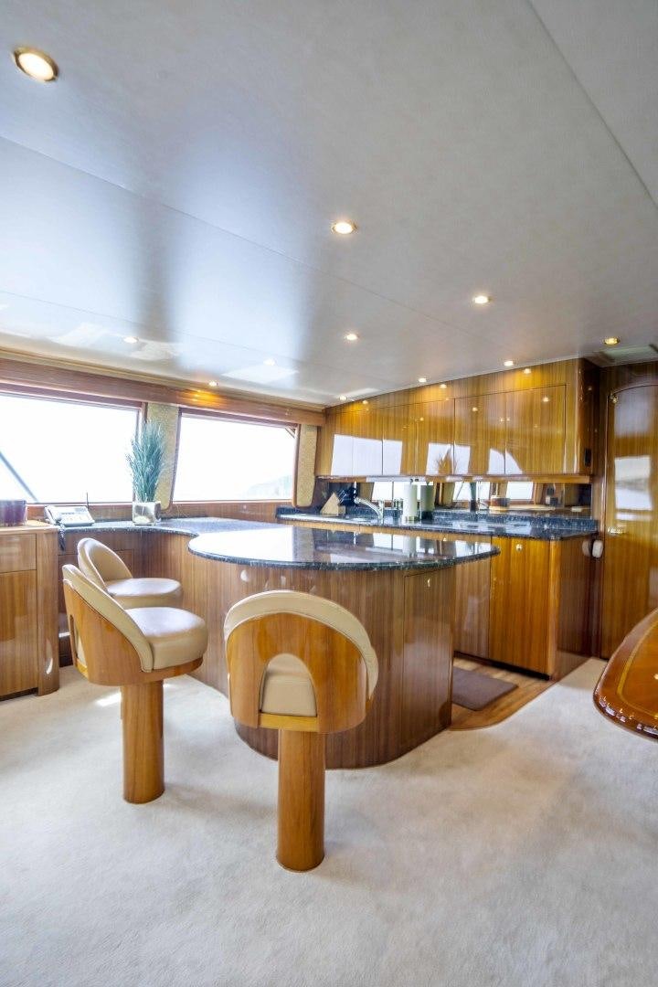 a kitchen with a bar stool aboard TRANQUILO Yacht for Sale