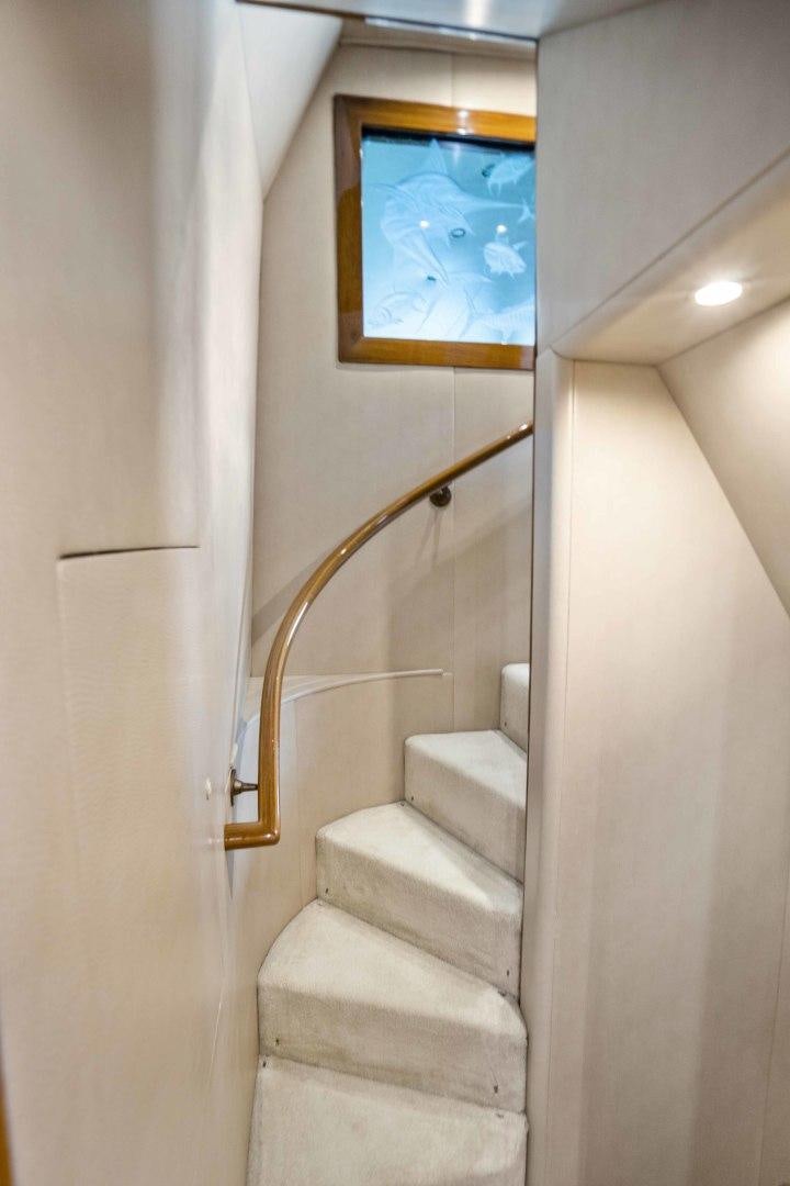 a stairway with a painting on the wall aboard TRANQUILO Yacht for Sale