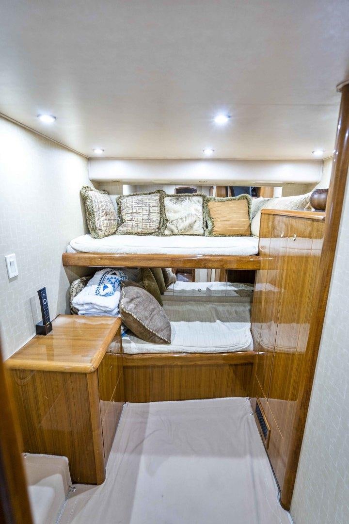 a bed with a wooden frame aboard TRANQUILO Yacht for Sale