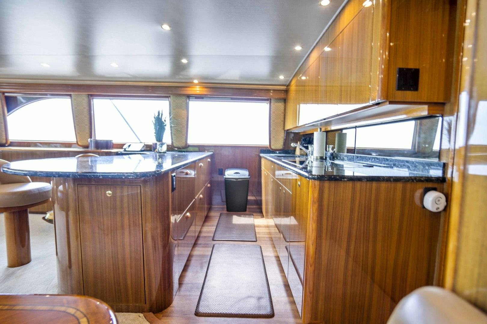 a kitchen with wooden cabinets aboard TRANQUILO Yacht for Sale
