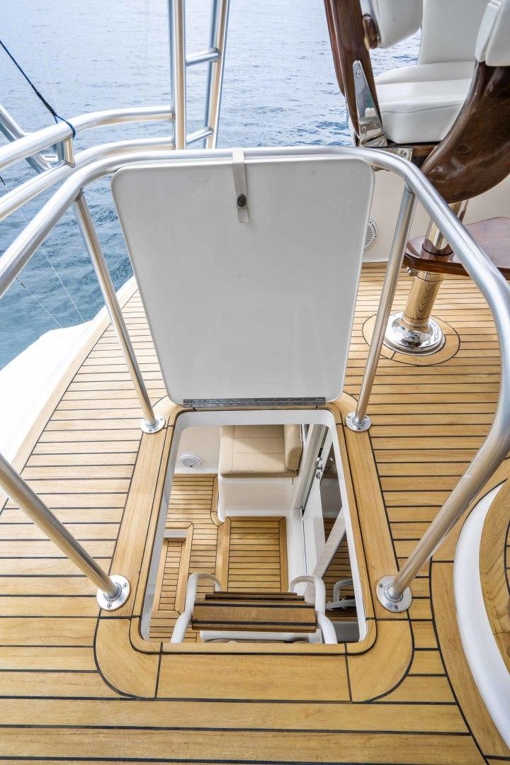 a white chair on a wooden deck aboard TRANQUILO Yacht for Sale