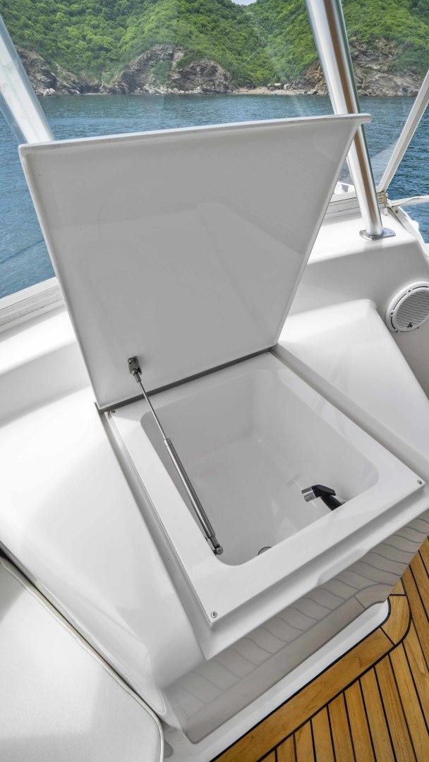 a white boat on a body of water aboard TRANQUILO Yacht for Sale