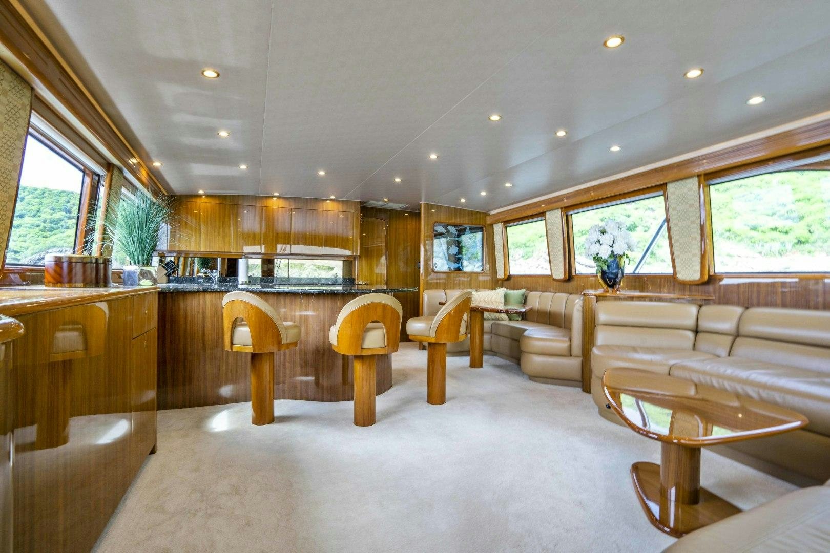a large living room with a large wood table and chairs aboard TRANQUILO Yacht for Sale
