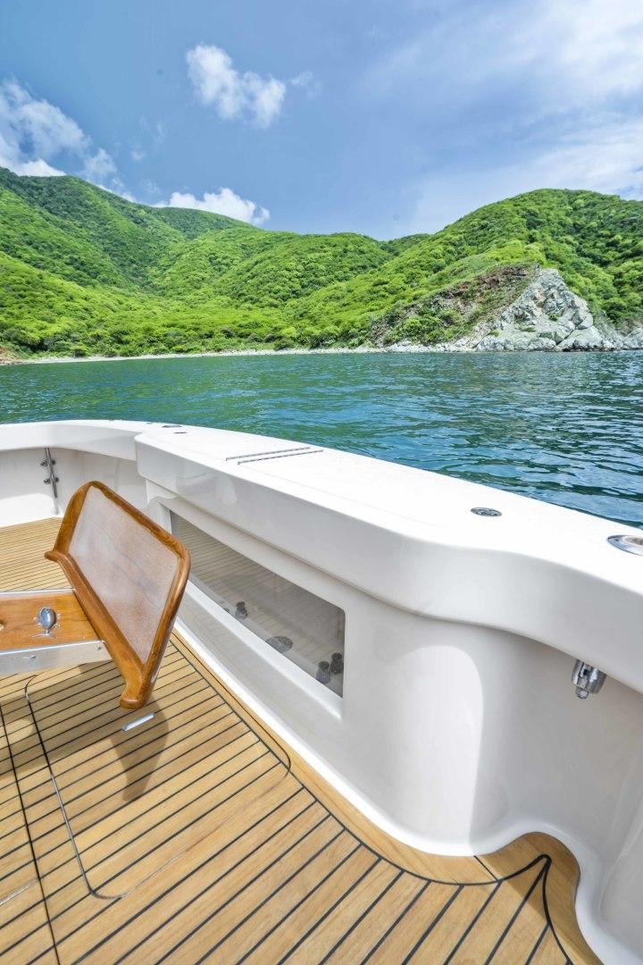 a wooden deck overlooking a body of water aboard TRANQUILO Yacht for Sale
