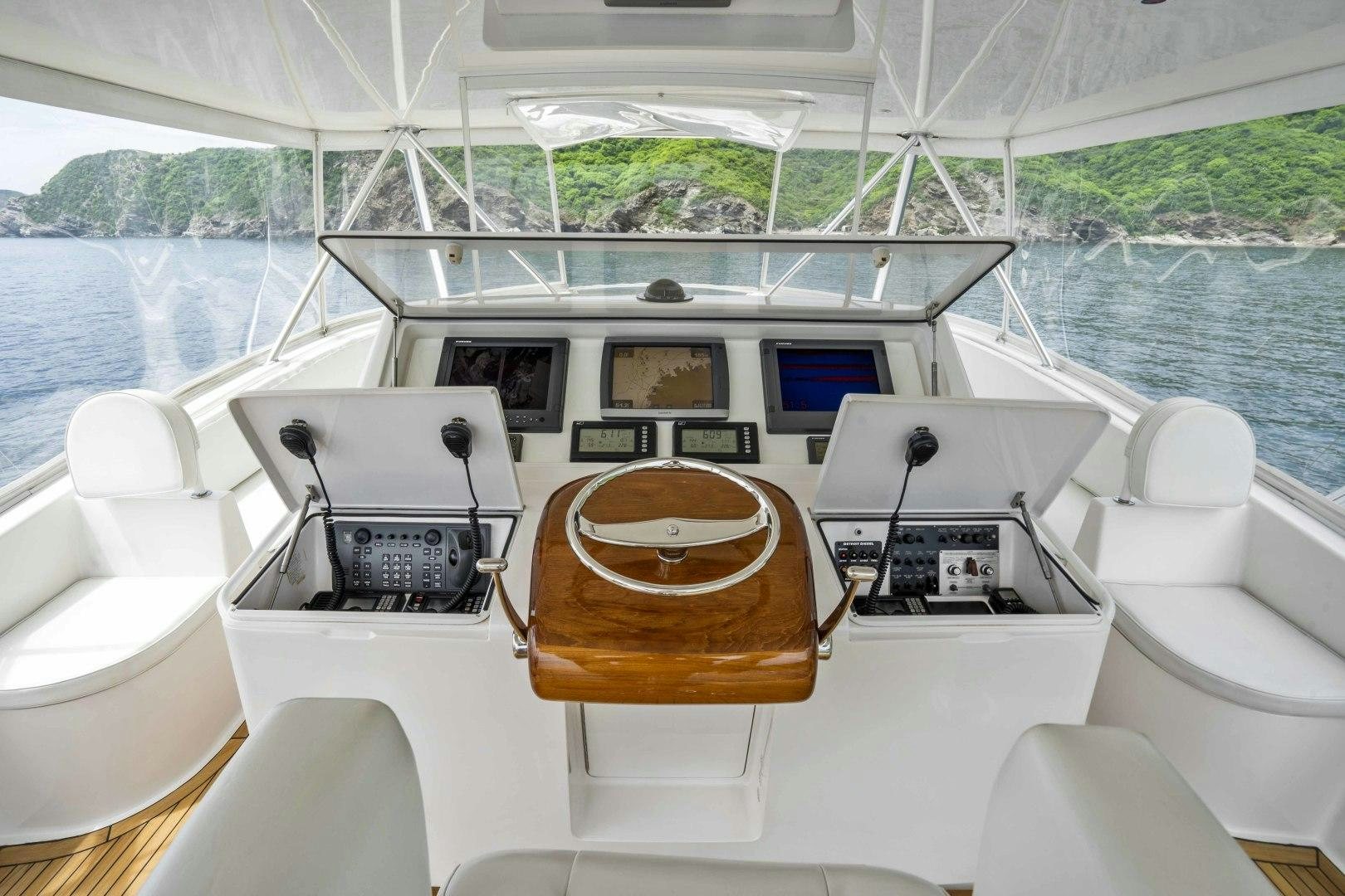 a boat with a wood steering wheel aboard TRANQUILO Yacht for Sale