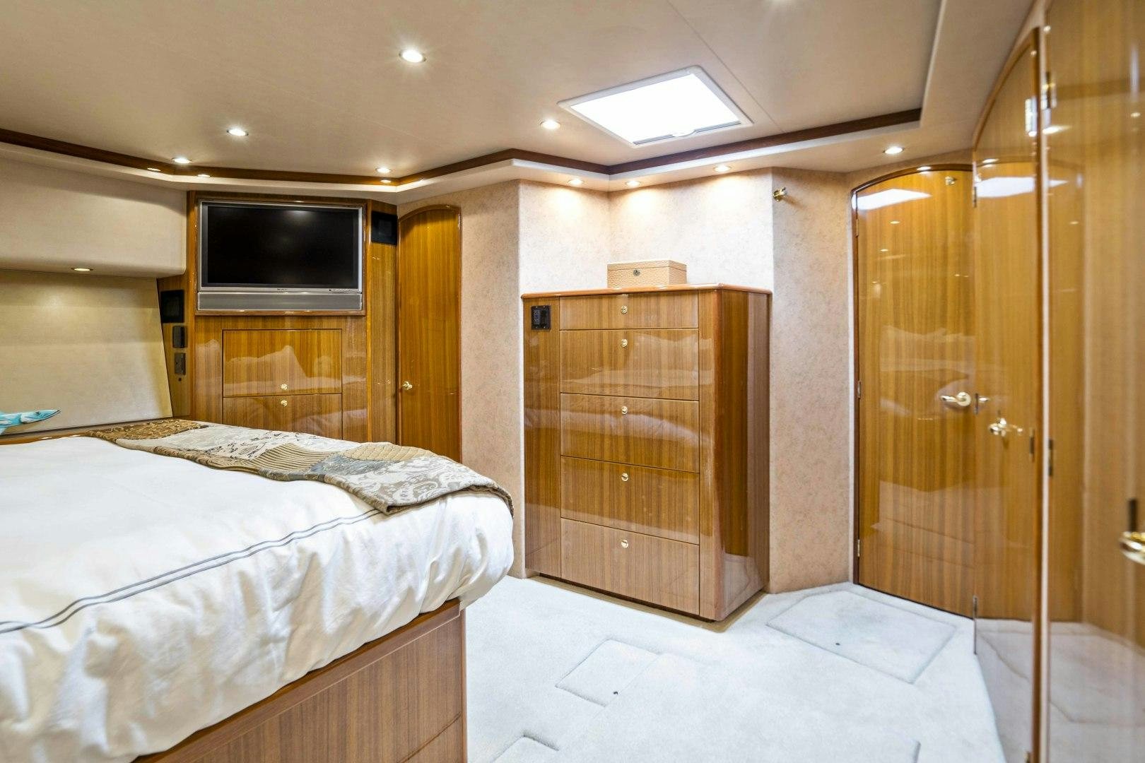 a room with a bed and a television aboard TRANQUILO Yacht for Sale