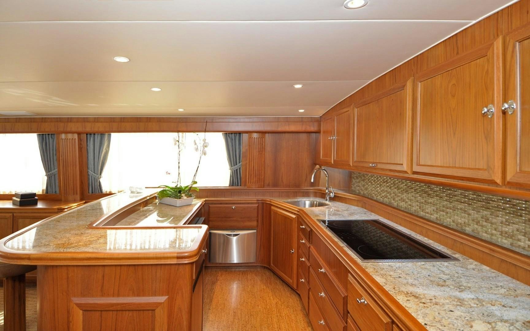 a kitchen with wooden cabinets aboard ONE MORE DAY Yacht for Sale