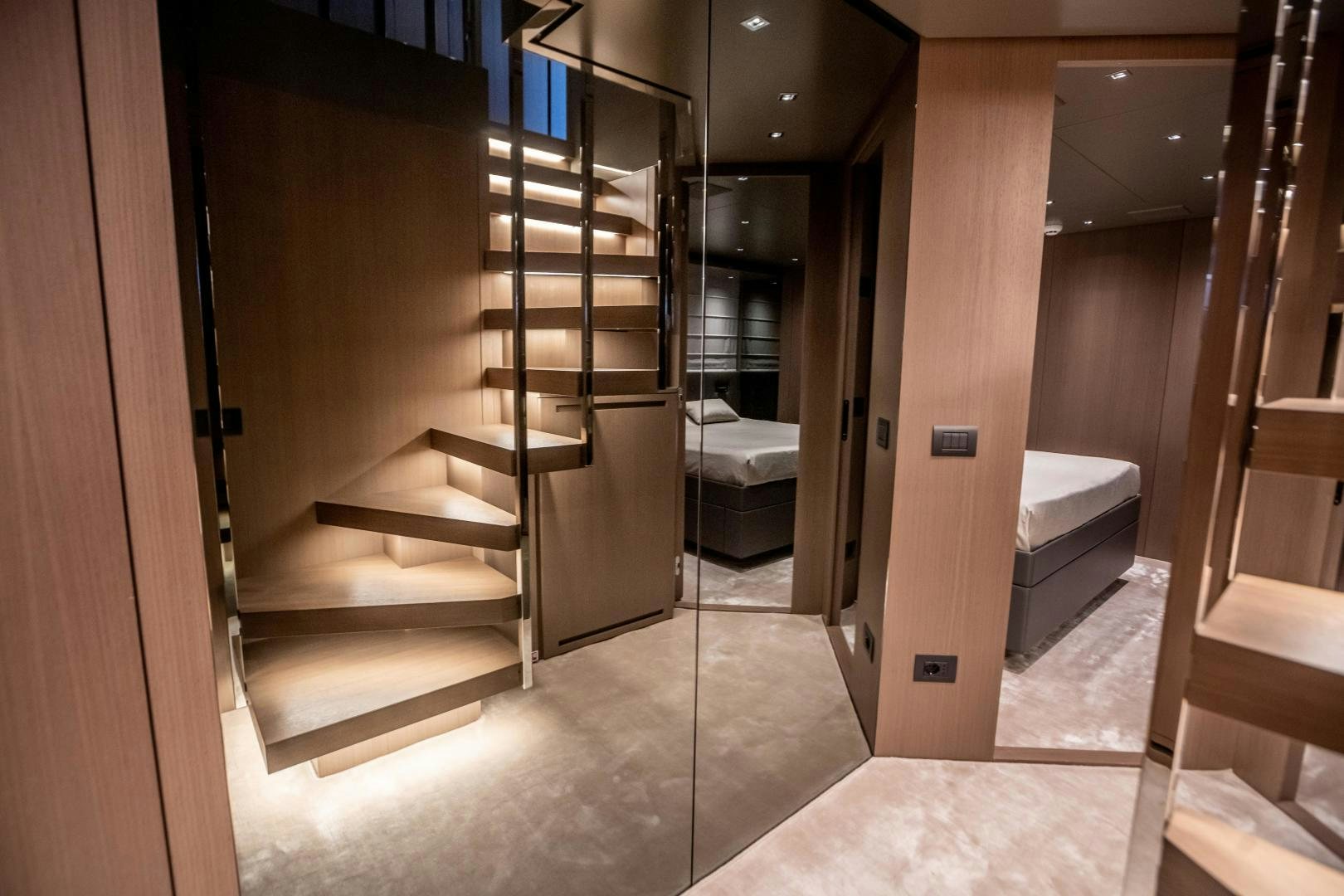a hallway with a bed and a door aboard ACE Yacht for Sale