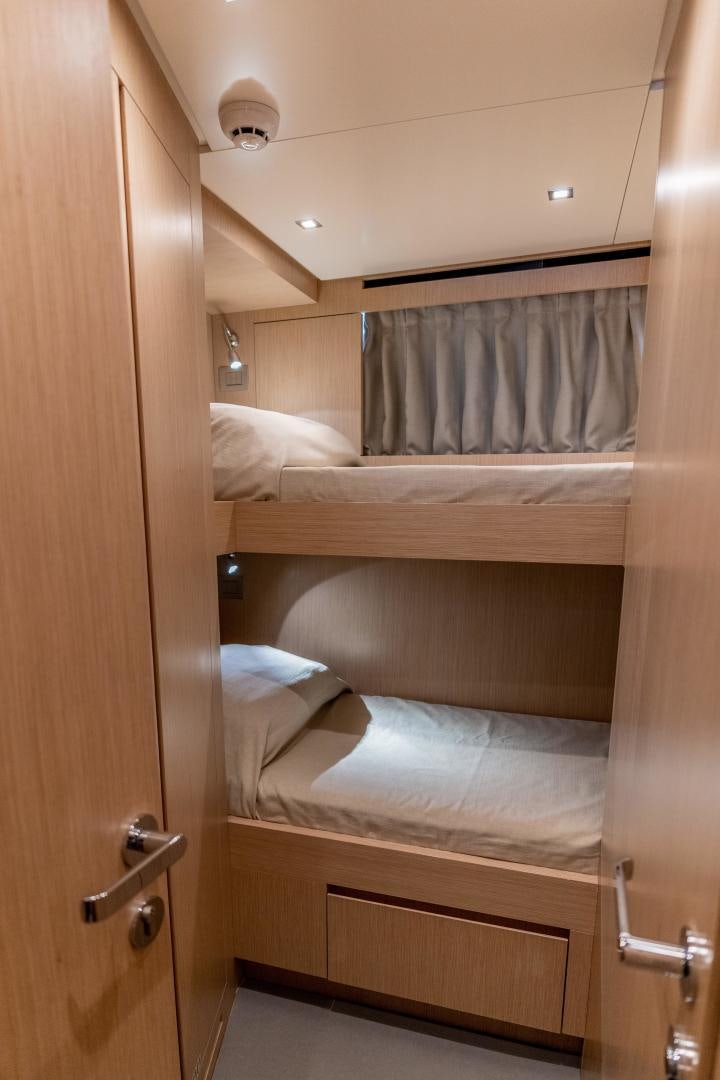 a room with a bed and a closet aboard ACE Yacht for Sale