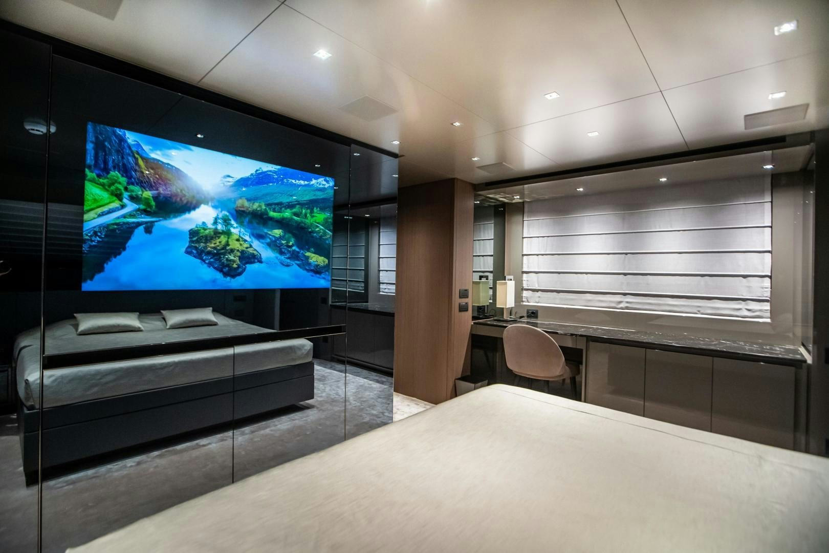 a large television screen in a room aboard ACE Yacht for Sale