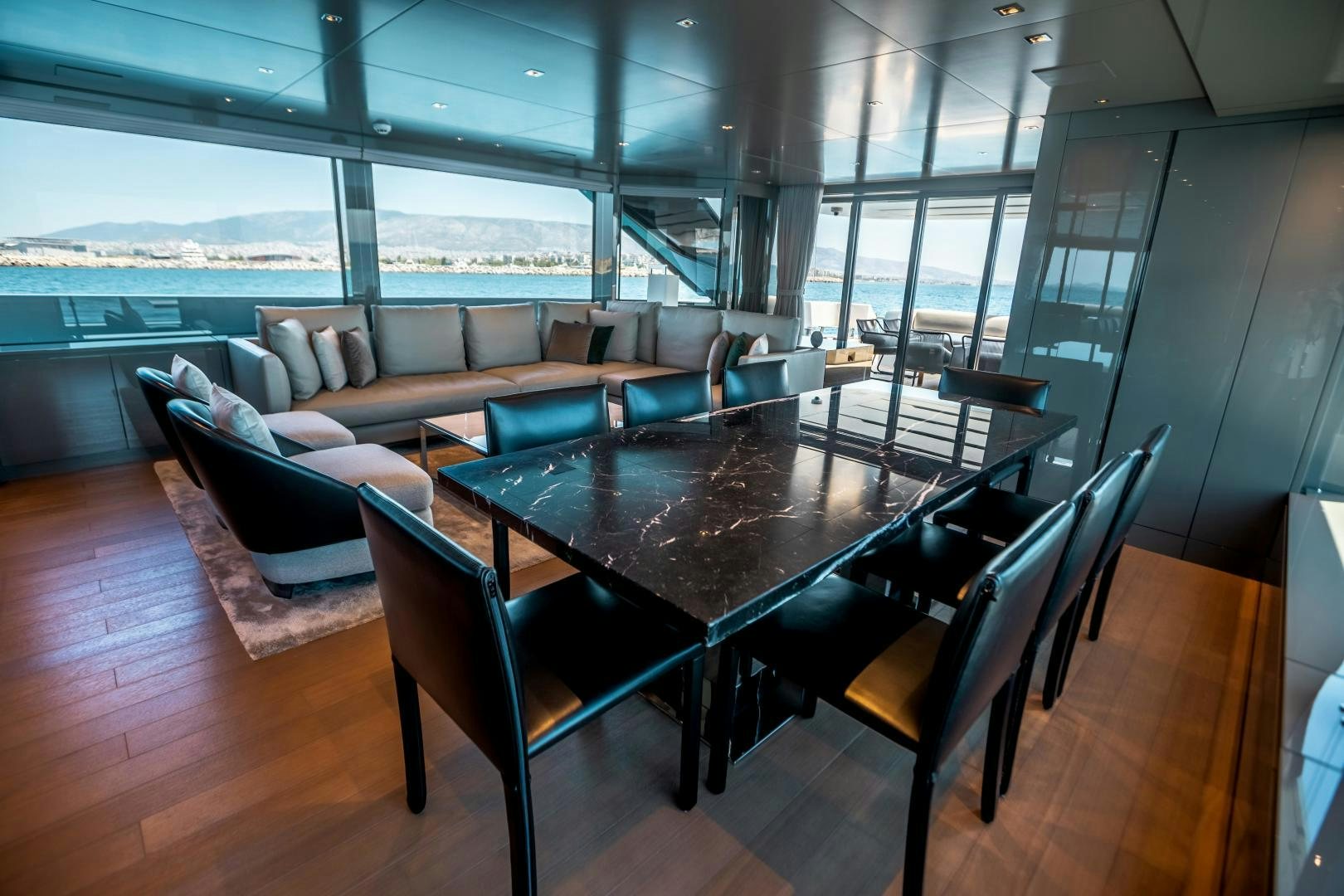 a large room with a table and chairs aboard ACE Yacht for Sale