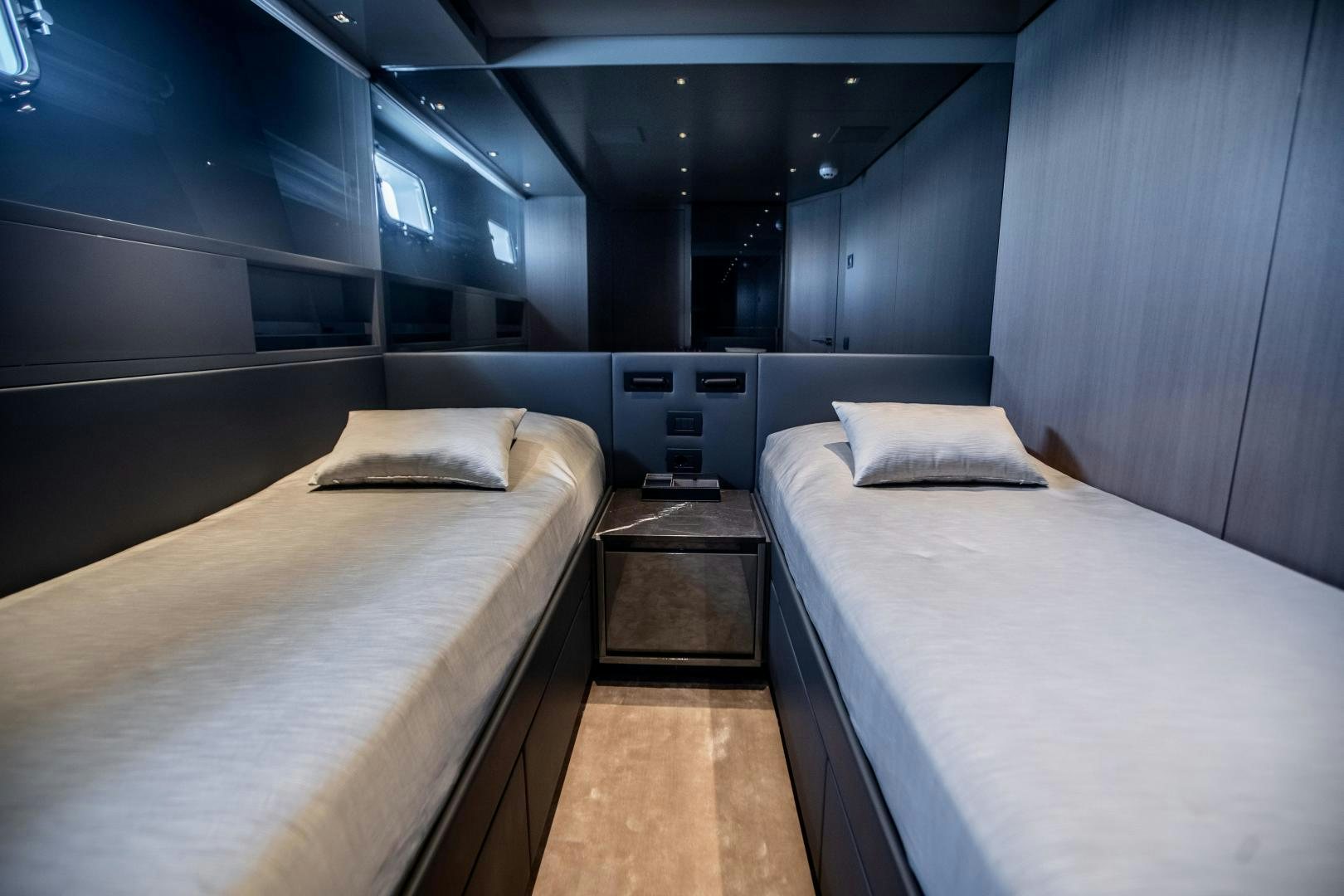 a room with two beds aboard ACE Yacht for Sale