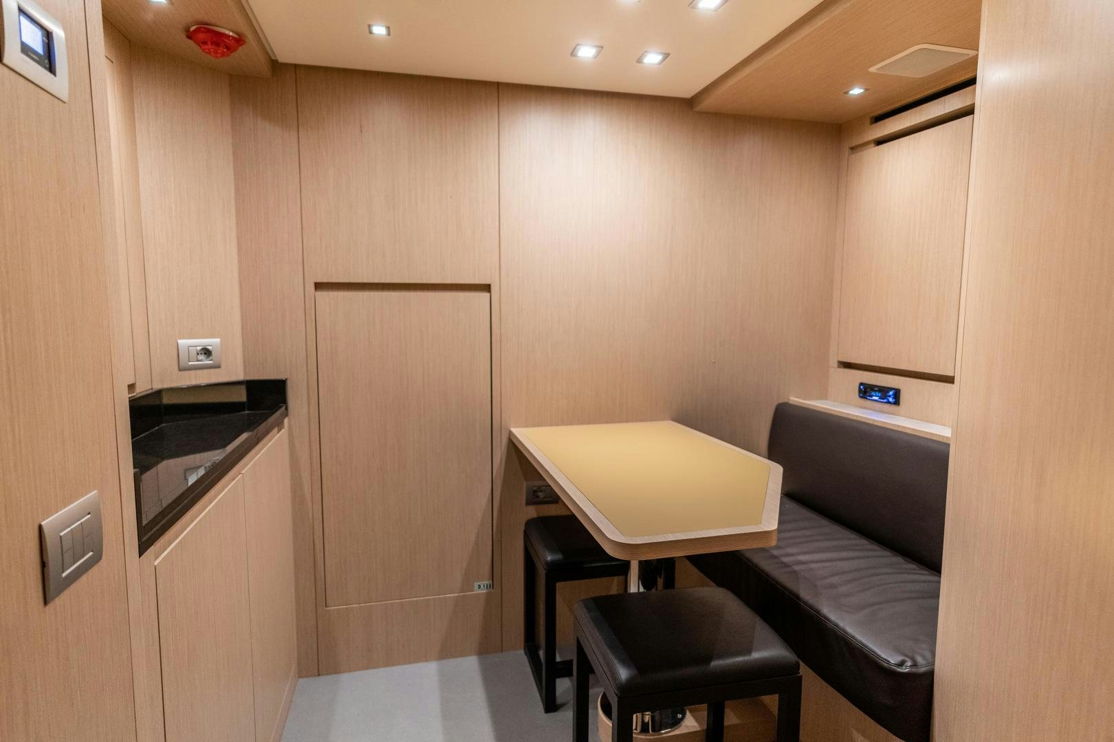 a room with a table and chairs aboard ACE Yacht for Sale