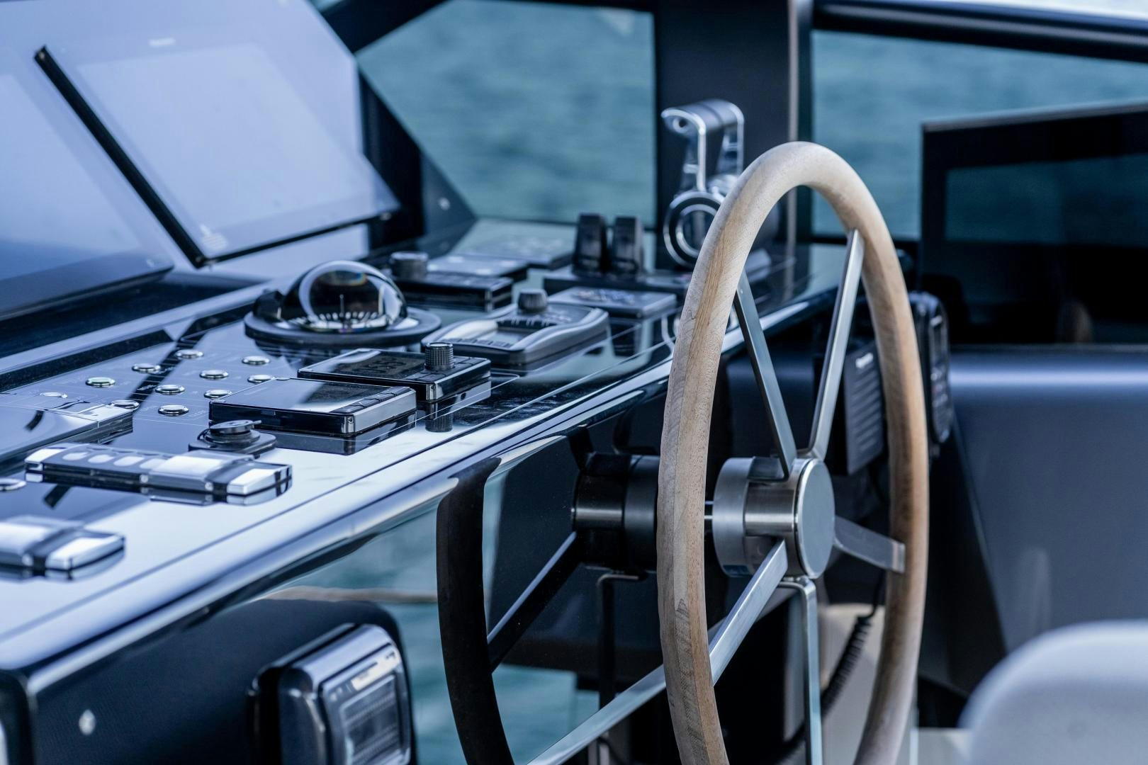 a close-up of a car's steering wheel aboard ACE Yacht for Sale