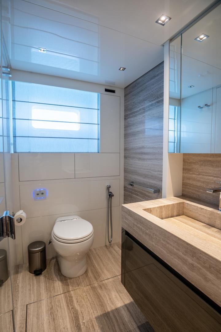 a bathroom with a tub toilet and sink aboard ACE Yacht for Sale
