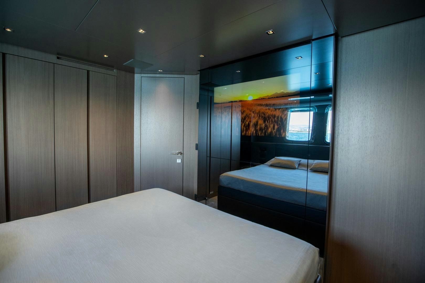 a room with a bed and a closet aboard ACE Yacht for Sale