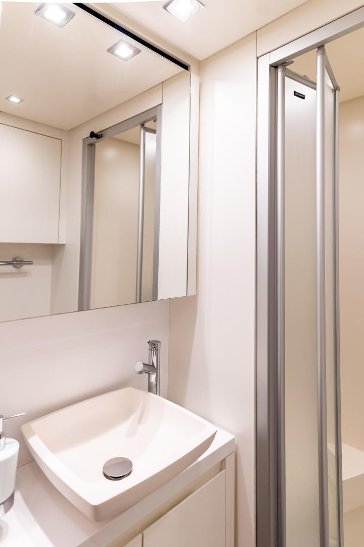 a bathroom with a sink and a shower unit aboard ACE Yacht for Sale