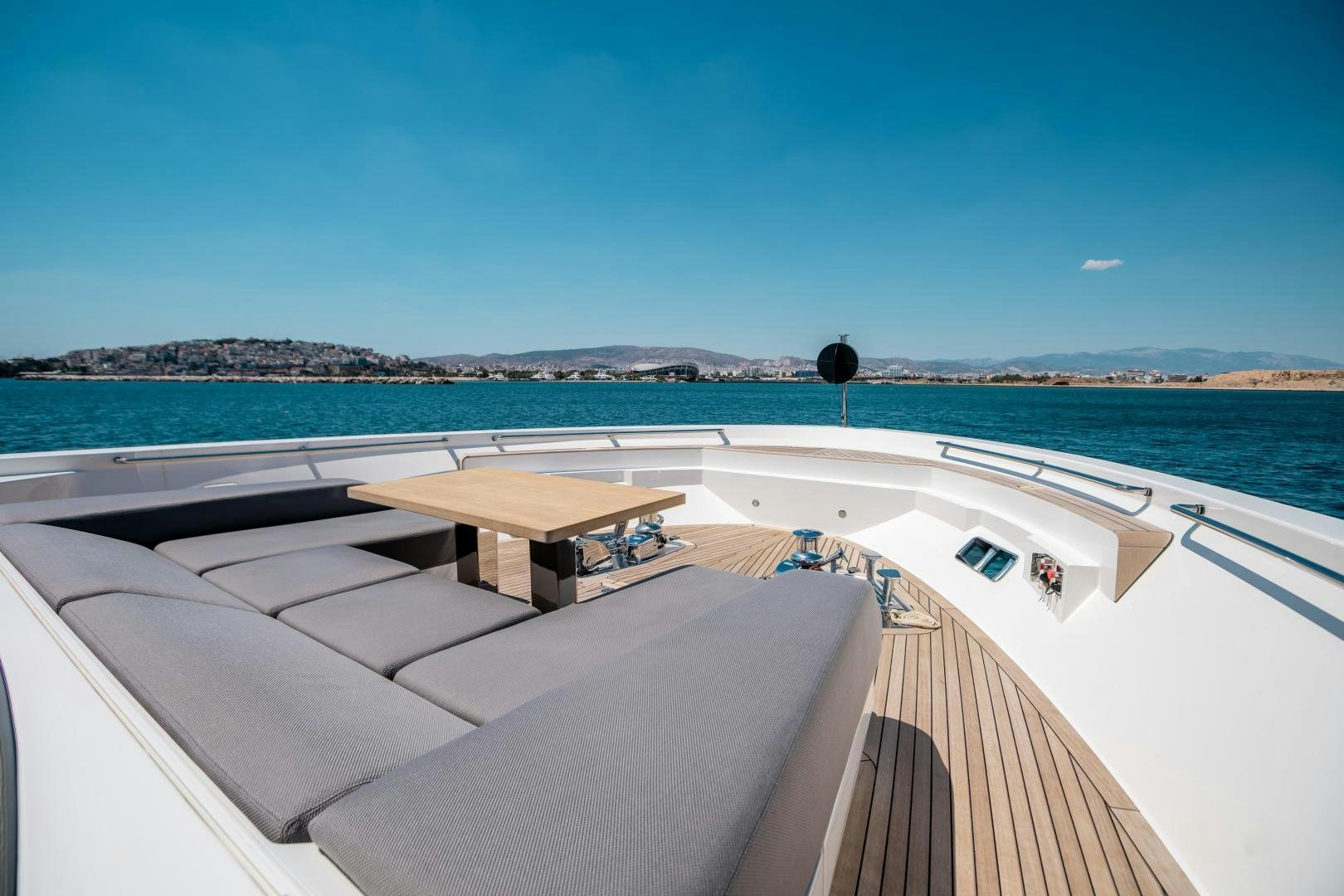 a deck with a view of the ocean and a beach aboard ACE Yacht for Sale