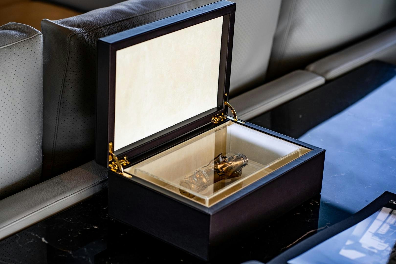 a gold and silver object on a black box aboard ACE Yacht for Sale